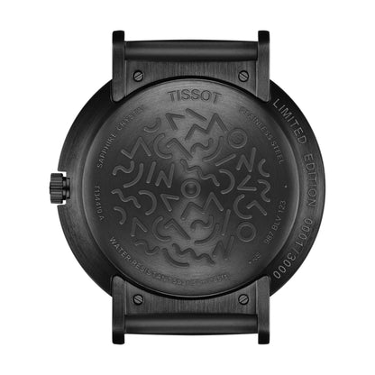 Black Tissot watch back cover with intricate design on a white background