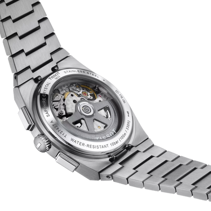 Close-up of a silver watch with visible brand name on a white background