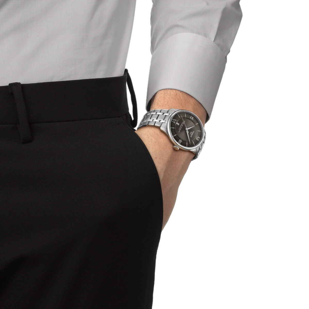 Person wearing a silver watch on a white background
