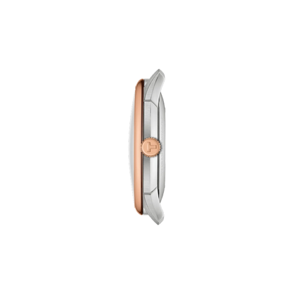 Close-up of a watch with a rose gold and silver design on a white background