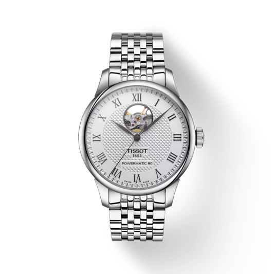 Silver Tissot watch with a white face on a light gray background