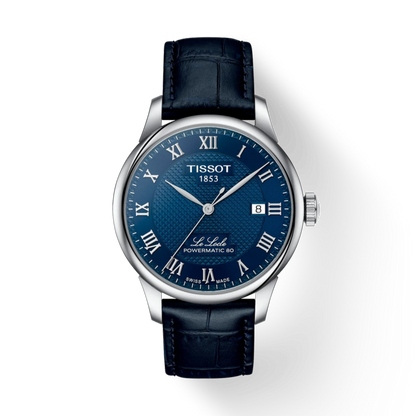 Tissot watch with blue face and black leather strap on a white background