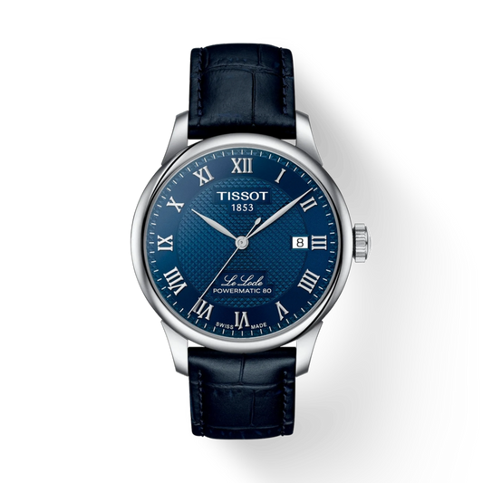 Tissot watch with blue face and black leather strap on a white background