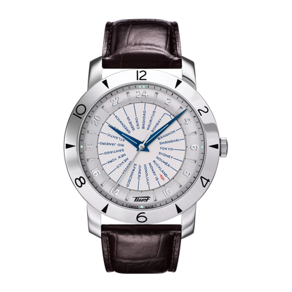 A Tissot Heritage Navigator Automatic men's watch with a white dial, blue hands, and a brown leather strap.