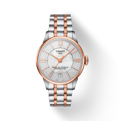 Tissot watch with silver and rose gold band on a white background