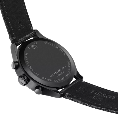 Black Tissot watch with detailed case back on a white background
