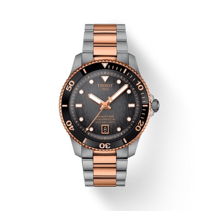 Tissot watch with rose gold and silver band on white background