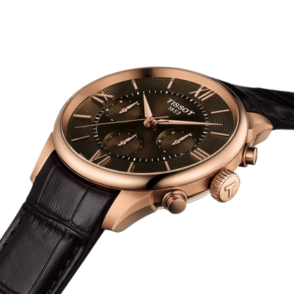 Tissot watch with black dial and rose gold case on a white background