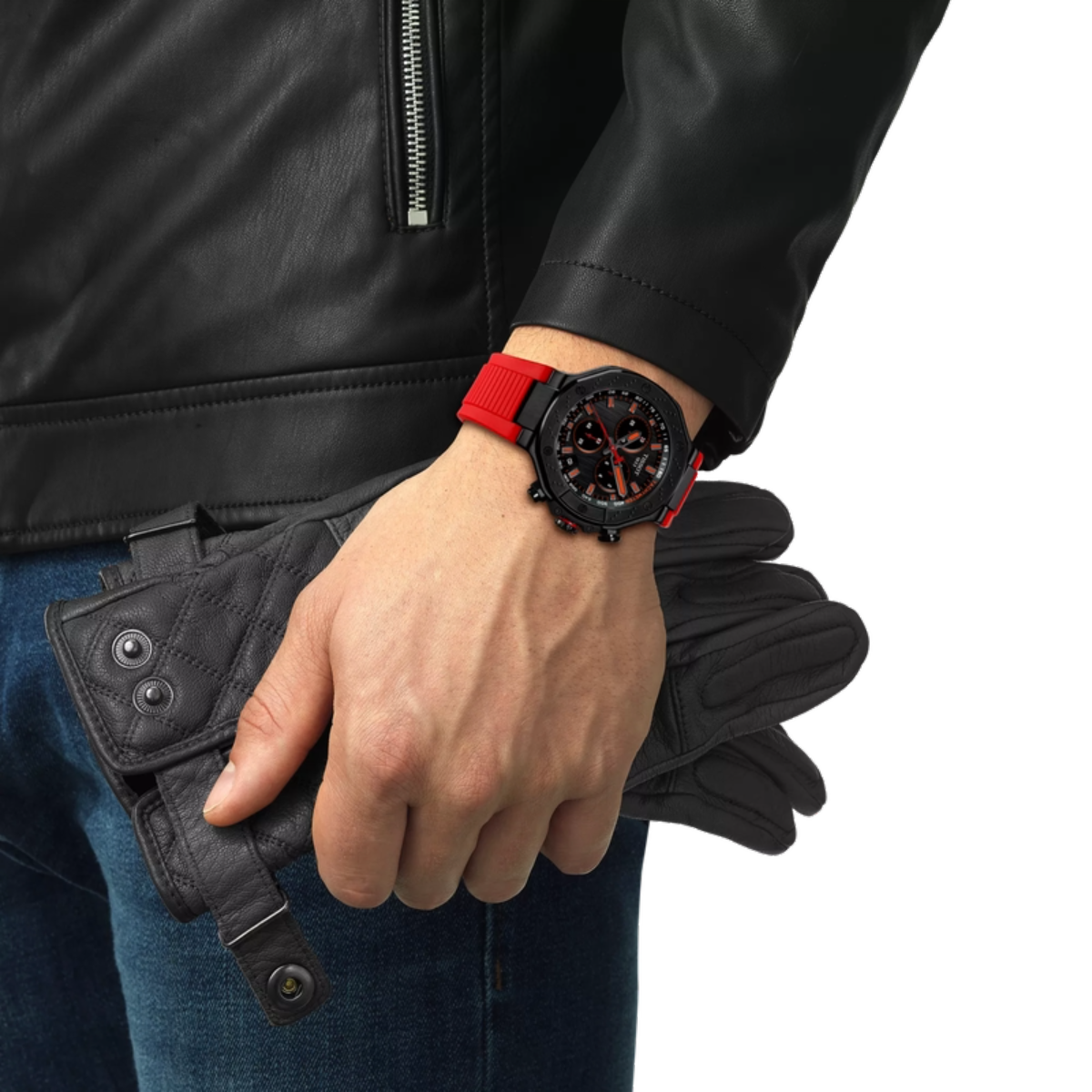 Person wearing a black leather jacket and blue jeans, holding a black wallet, with a focus on a red wristwatch.