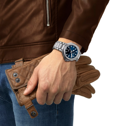 Hand wearing a silver watch with a blue face, holding a brown leather wallet, against a white background.