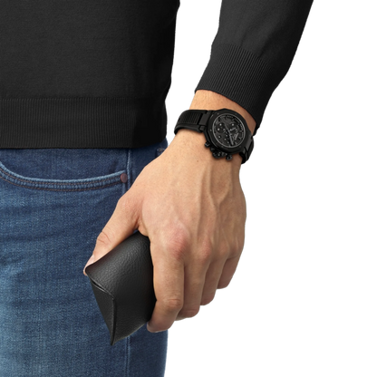 Hand wearing a black watch holding a black wallet, with a plain background