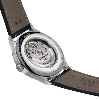 Close-up of a Tissot watch with visible brand name and mechanism details.
