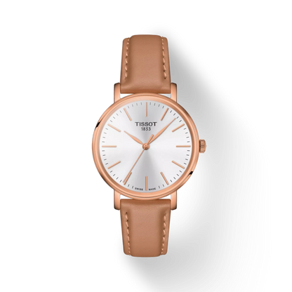 Tissot watch with brown leather strap and rose gold case on white background