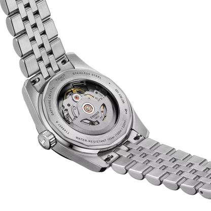 Close-up of a silver watch with a visible mechanical movement on a white background