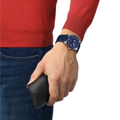 Person wearing a red sweater and blue jeans with a blue watch on a white background
