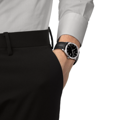 Person wearing a black watch on a white background