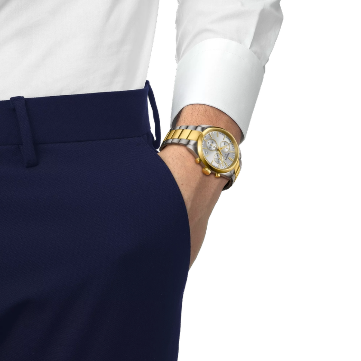 Gold watch on a person's wrist with a white shirt and navy pants against a white background