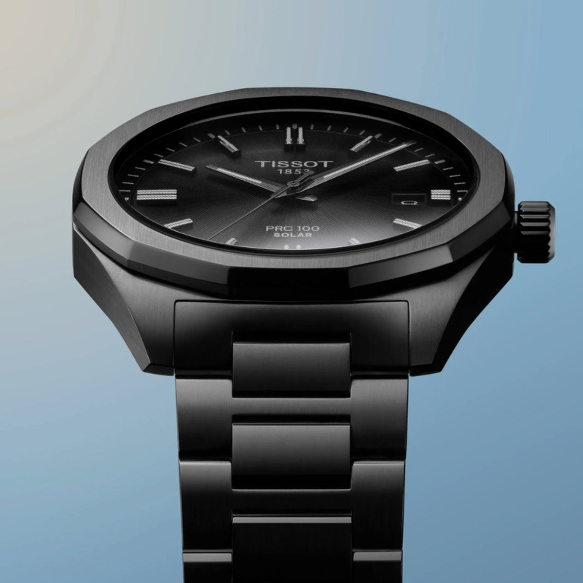 Black Tissot watch on a gradient blue background