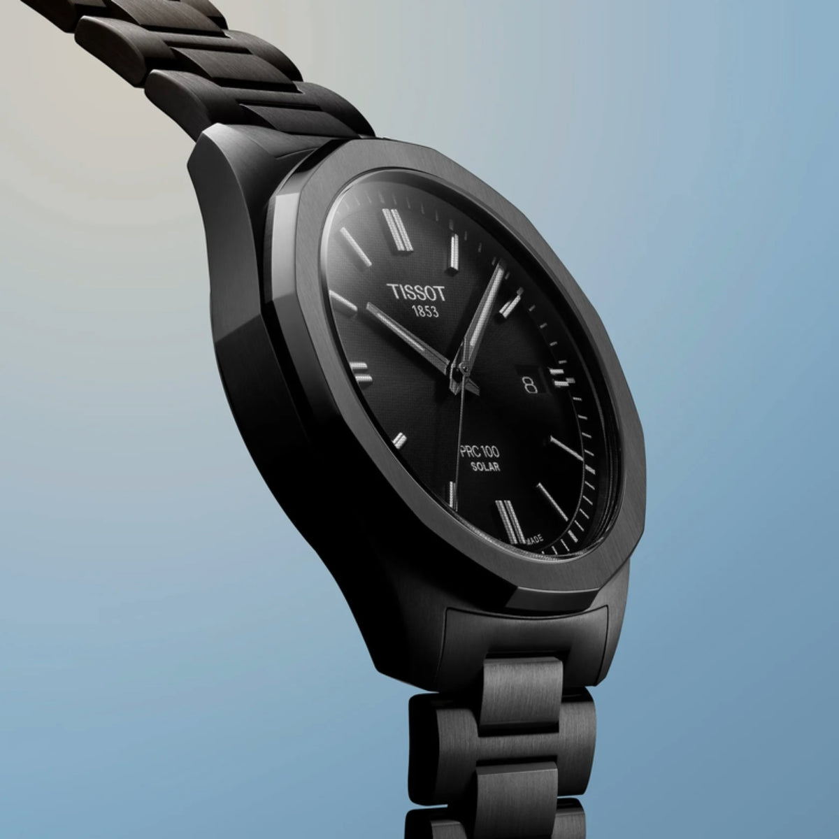 Black Tissot watch on a gradient blue background