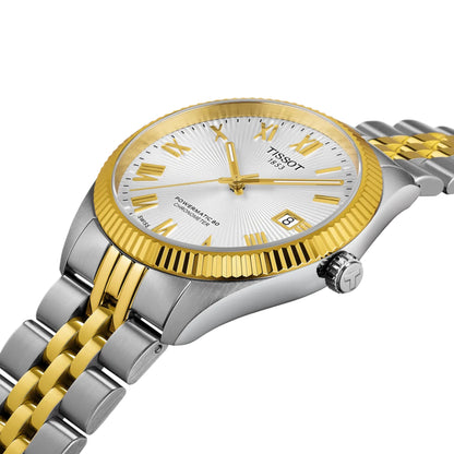 Two-tone silver and gold Tissot watch on a white background