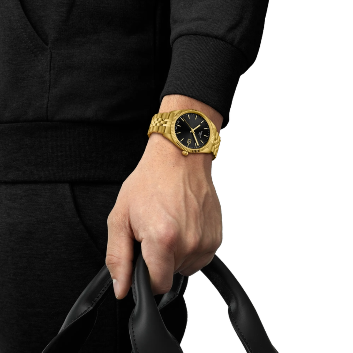 Gold wristwatch on a person's wrist with a black background