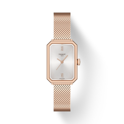 Rose gold Tissot watch with a white face on a light gray background