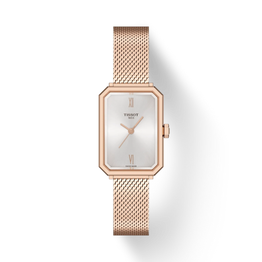 Rose gold Tissot watch with a white face on a light gray background
