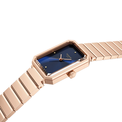 Rose gold watch with blue face on a white background