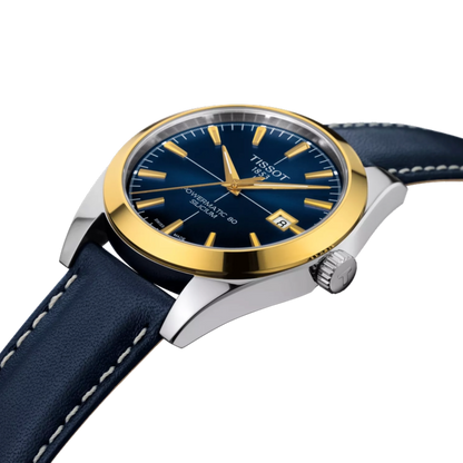 Tissot watch with blue strap and gold bezel on a white background