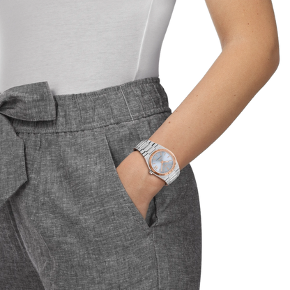 Person wearing a silver watch with a white background