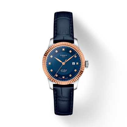 Luxury watch with blue dial and rose gold bezel on a white background