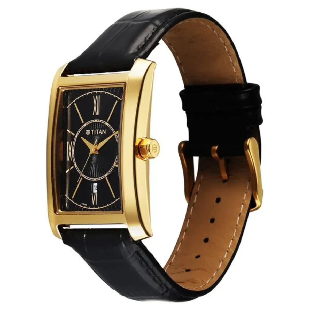 Titan watch with black leather strap and gold case on a white background