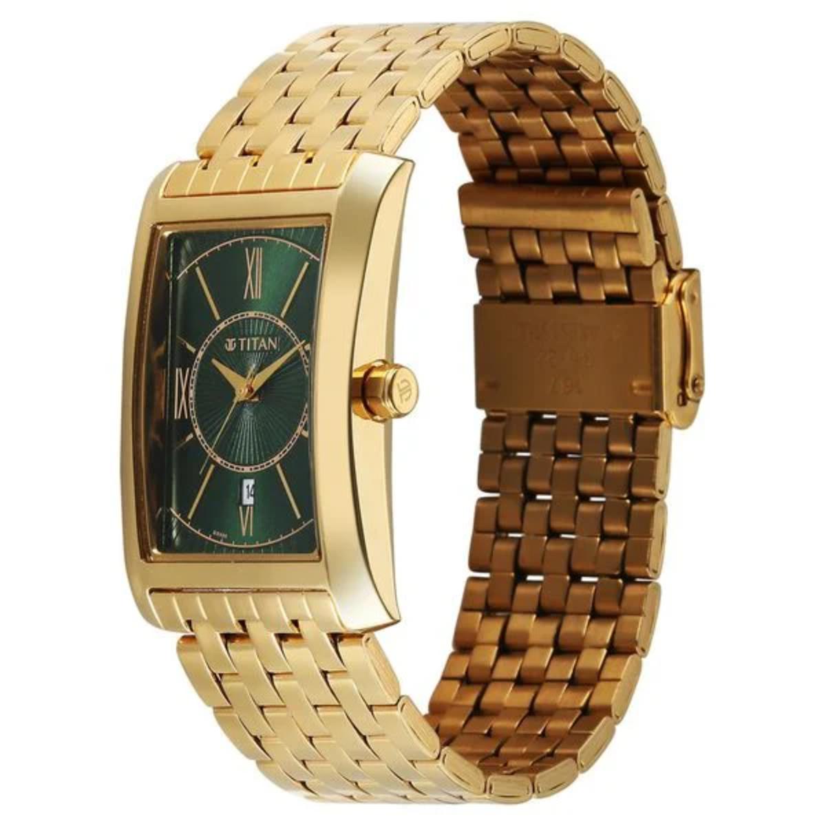 Gold watch with green face on a white background