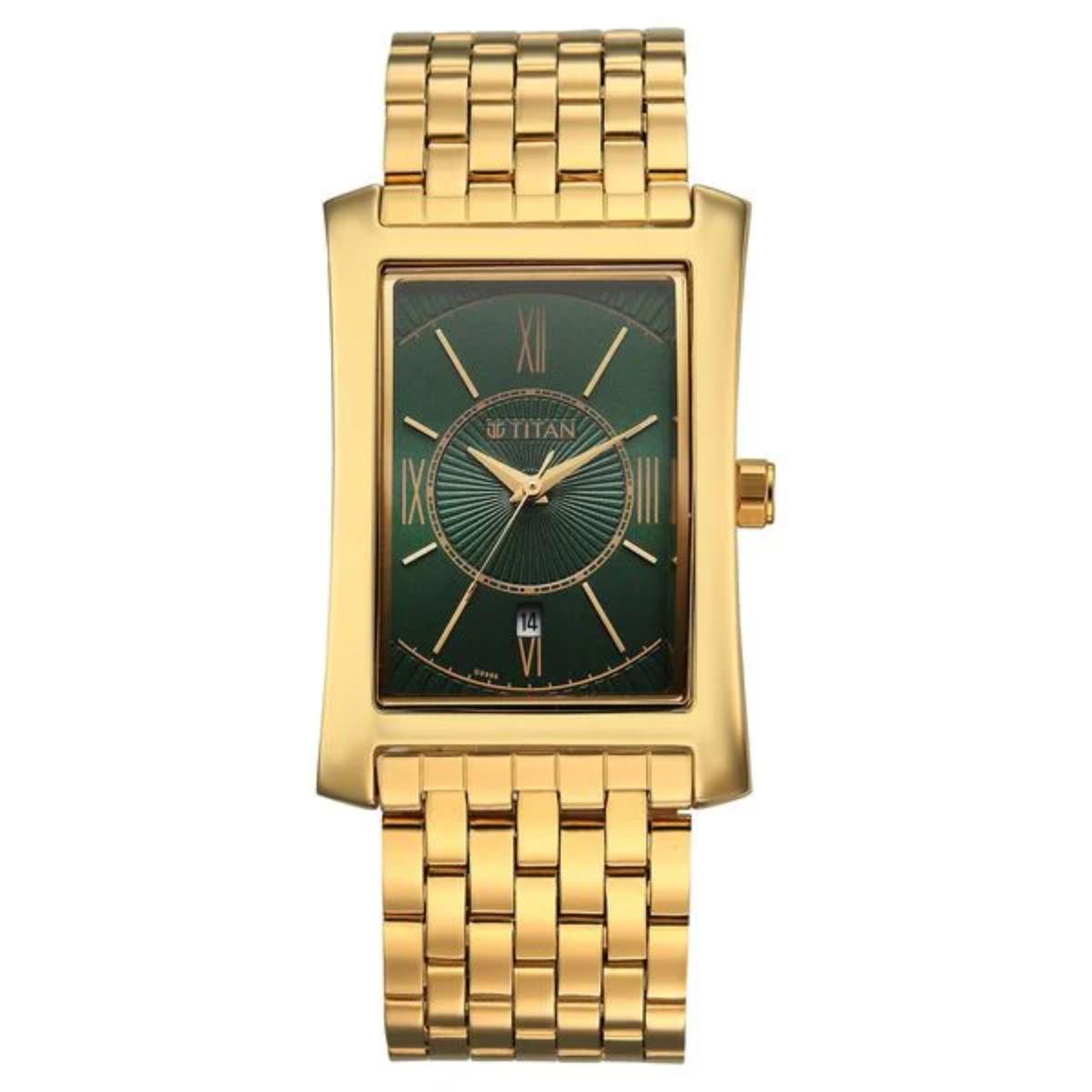 Gold wristwatch with a green face on a white background