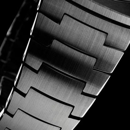 Close-up of a metallic watch strap with a textured surface