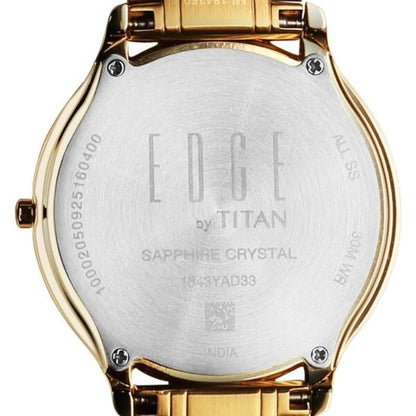 Gold watch case with 'EDGE by TITAN' engraving on a white background
