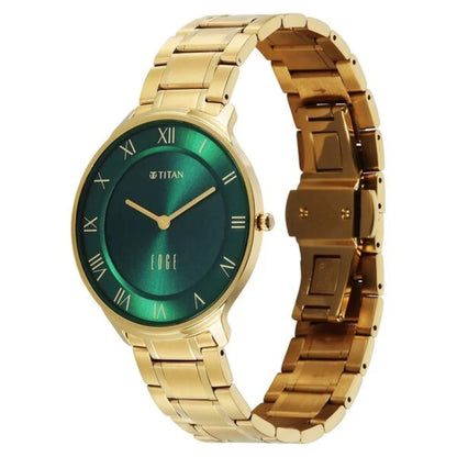 Gold wristwatch with a green face on a white background, featuring the Titan brand.