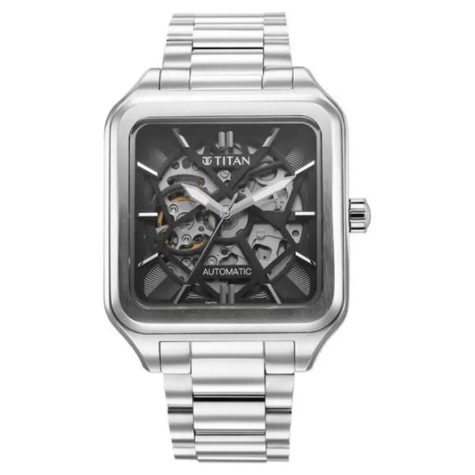 Titan watch with silver metal strap and transparent face on a white background