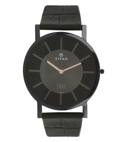 A TITAN Edge Revamp slim analog watch for men with a black dial and black leather strap.