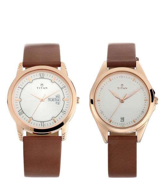 A pair of TITAN brand watches with silver-colored dials, one with a date display and stick indicators, the other with a simple analog display. Both watches have tan leather straps and rose gold-colored cases.