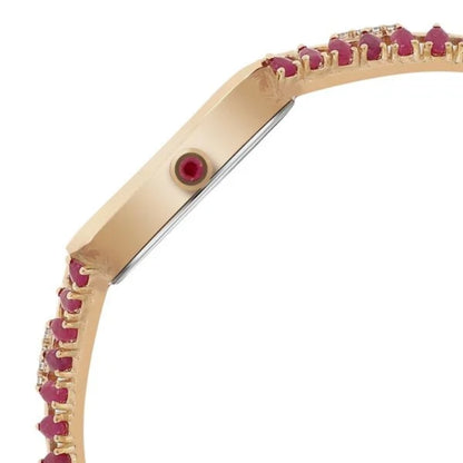Gold bracelet with red gemstones on a white background
