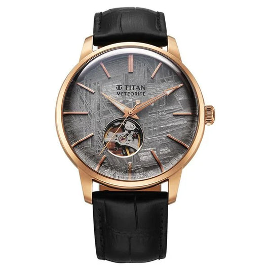 A Titan Stellar Automatic Watch with a grey dial, black leather strap, and a stainless steel case.