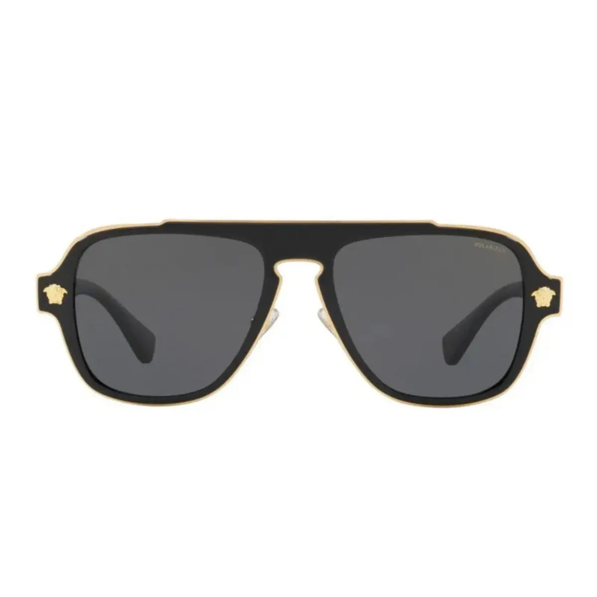 Sunglasses with gold frame and dark lenses on a white background