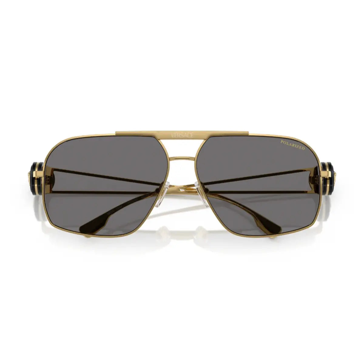 Gold-framed sunglasses with dark lenses on a white background