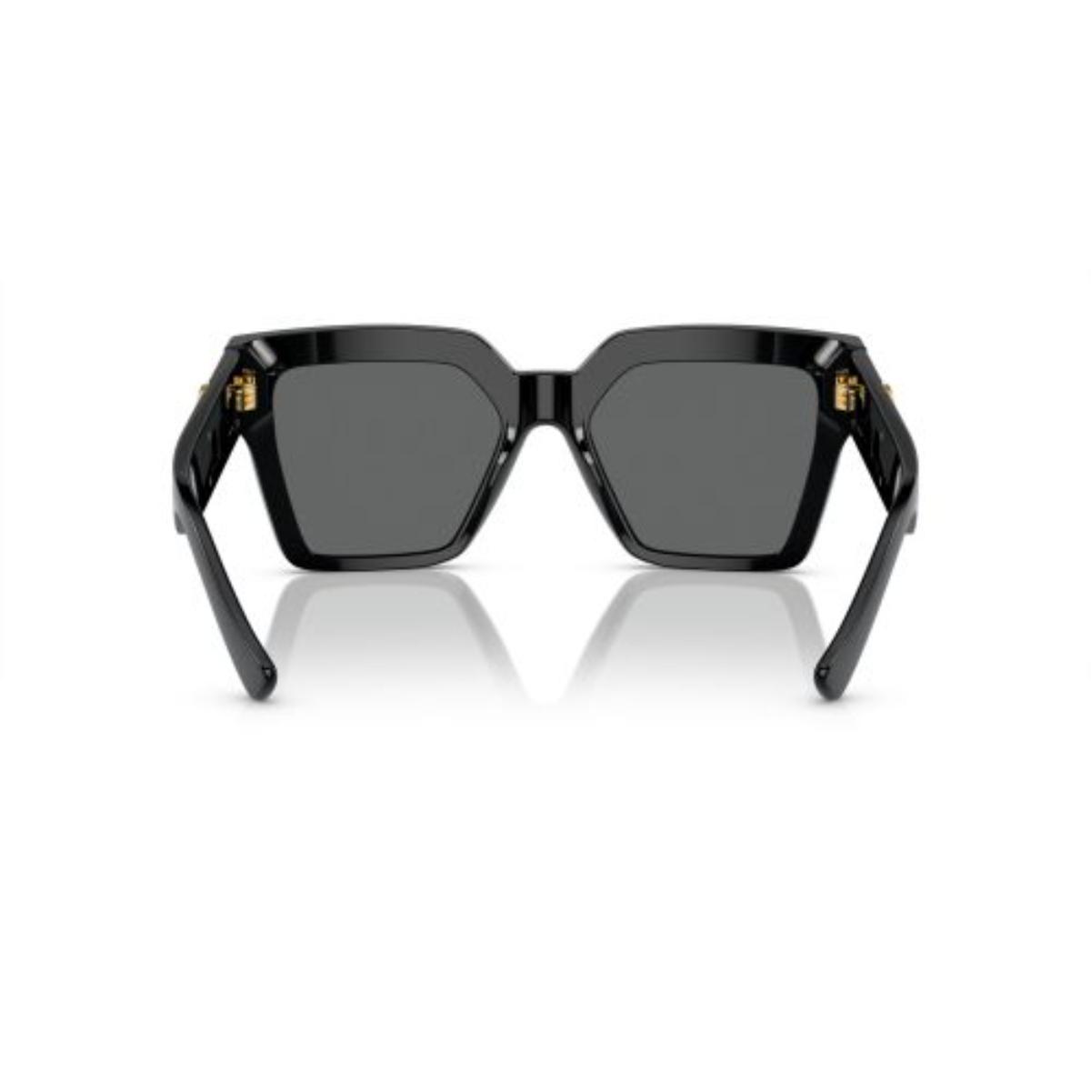 Black sunglasses with gold accents on a white background