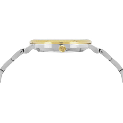 Gold and silver watch on a light gray background