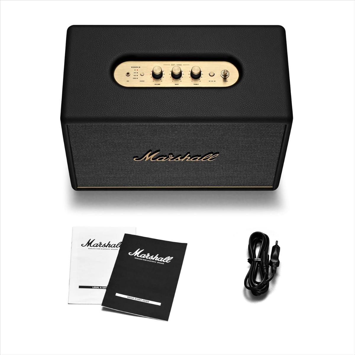 Marshall speaker with cables and manual on a white background