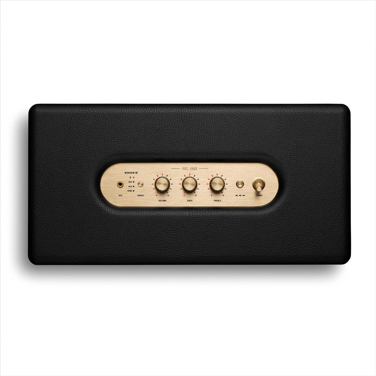 Black electronic device with wooden control panel on a white background
