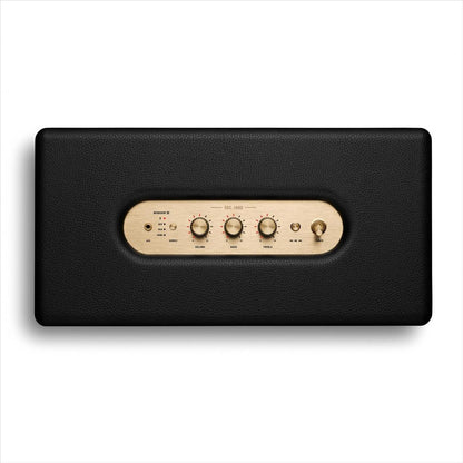 Black electronic device with wooden control panel on a white background