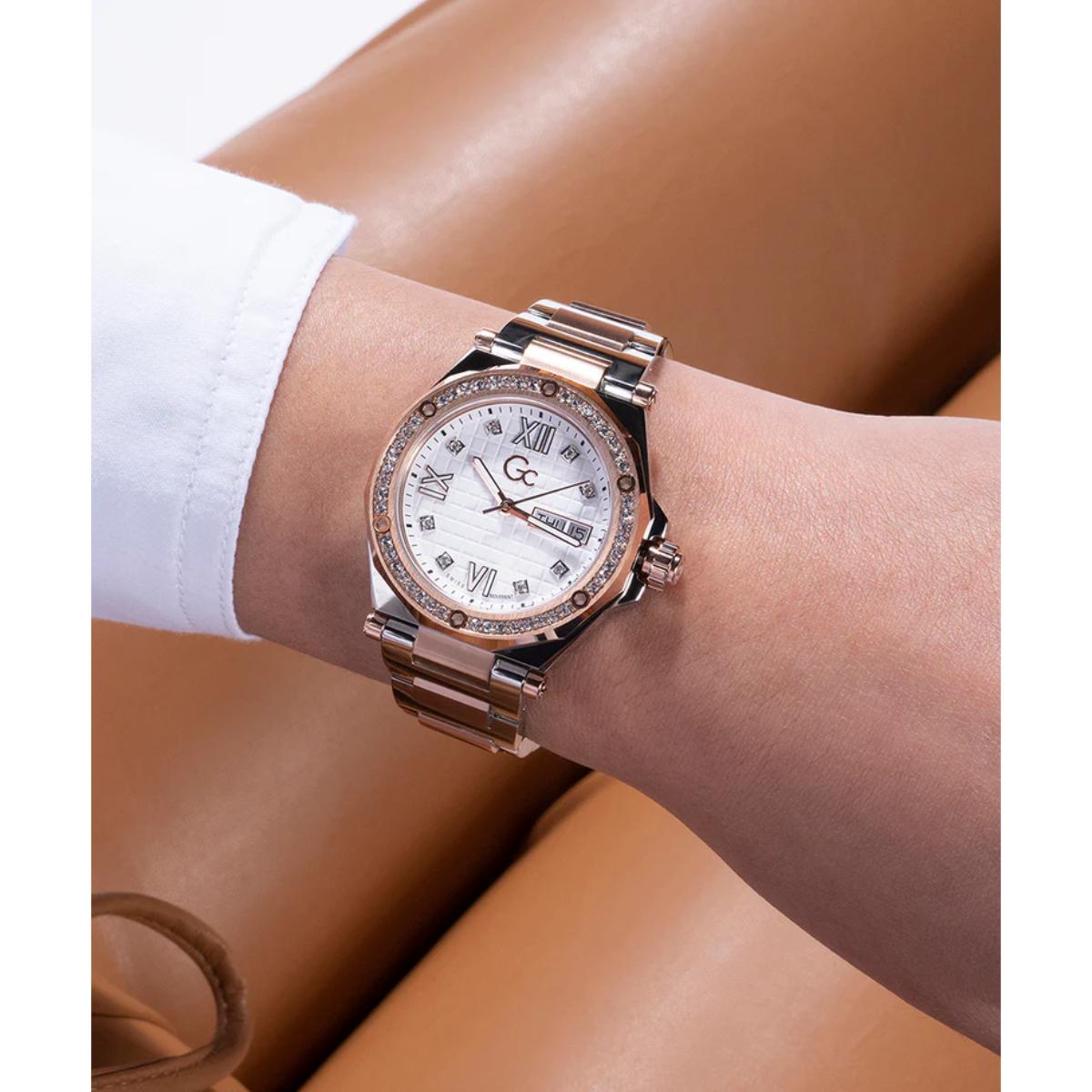 Rose gold watch with diamond accents on a wrist against a neutral background